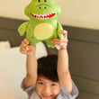 Load image into Gallery viewer, boy hold tooth fairy tooth pillow. the pillow is a t-rex dinosaur

